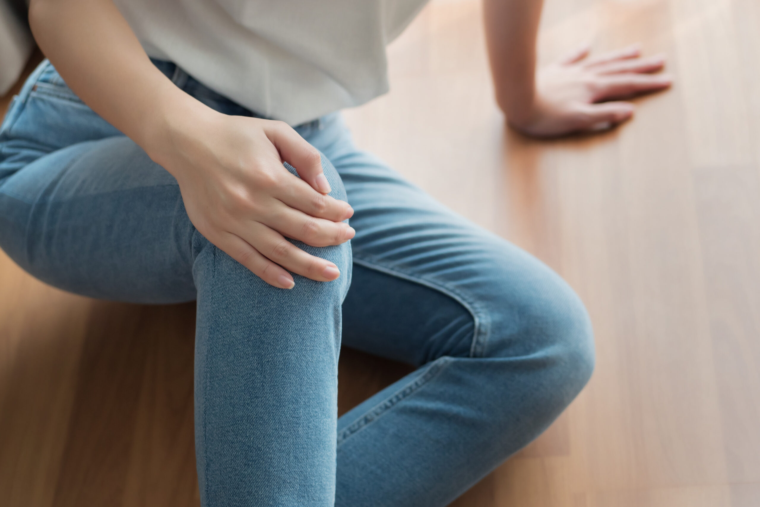 woman on floor with injured knee