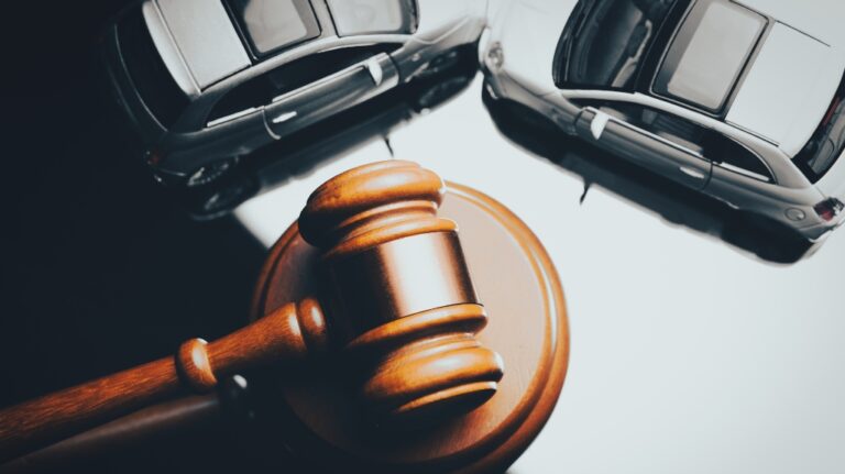 Model of car and gavel