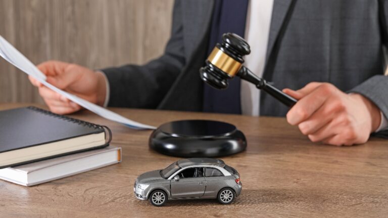 Man with document and gavel at wooden table