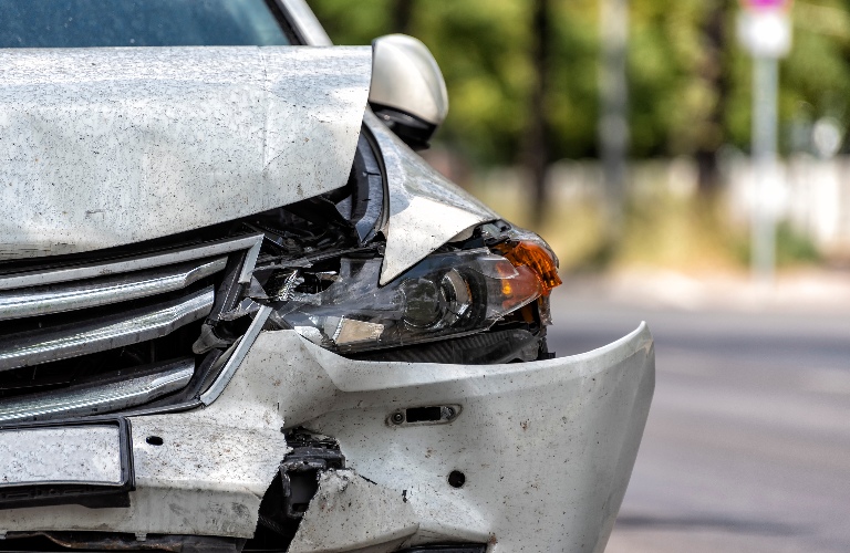heavy damaged car at the roadside after an accident