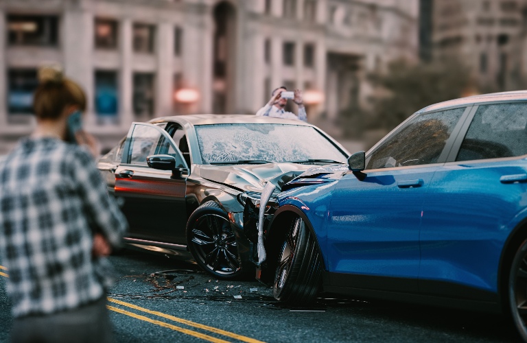 two cars crashed on the road